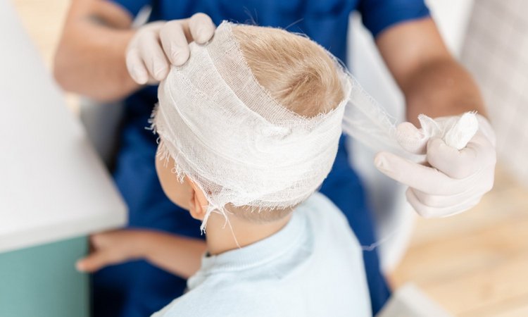Kind erhält einen Kopfverband